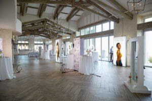 Photo of fall launch event, illuminated signs, ring lights, signs, tables with white linen, flowers