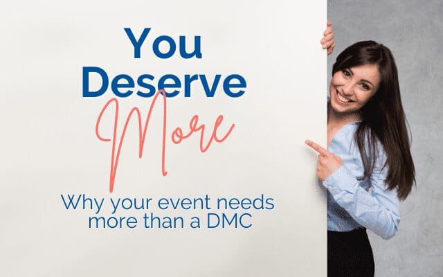 Photo of a woman pointing to a sign reading: You deserve more. Why your event needs more than a DMC