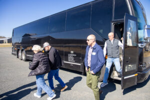 Photo of Guests getting off a bus Blue Spark