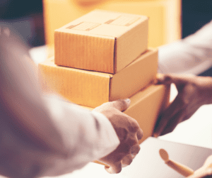 Photo of person handing boxes to another person