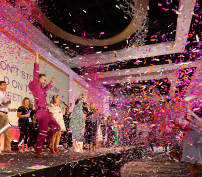 Blue Spark - Branded Orlando Corporate Conference Photo of Speakers on stage with Confetti Burst